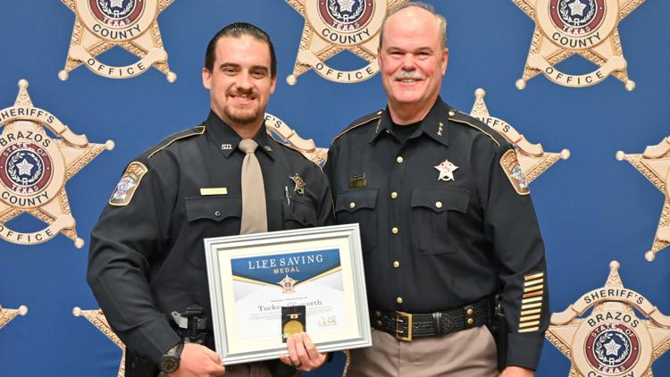 Deputy John Smith receiving the Life Saving Medal award