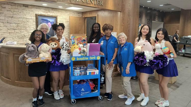 University High School Cheer squad donating toys to children at Providence Hospital.